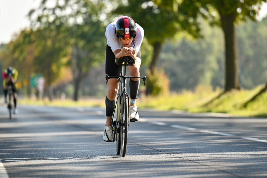 Professional triathlete in aerodynamic position during time trial